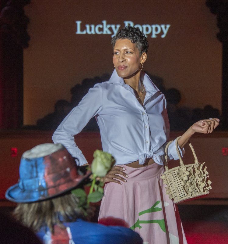 Cicely Everson struts in a Lucky Poppy combo skirt and top, with a basket-weave purse.